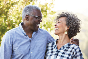 Mature man and woman looking at each other and laughing