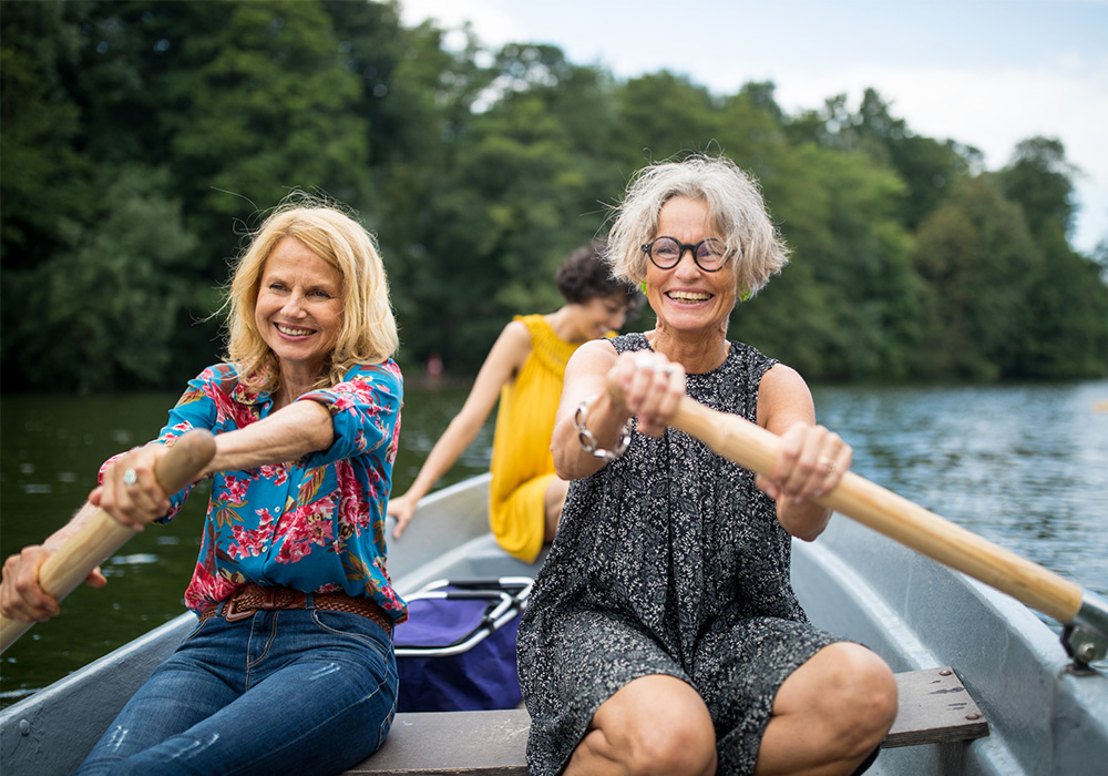 Trois femmes assises dans un canot sur un lac