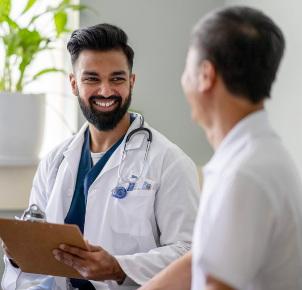Smiling doctor talking to patient
