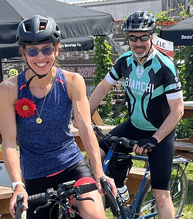 Happy woman and man cyclists wearing Myeloma Canada flower at Myeloma Canada Ride, Vankleek Hill, ON