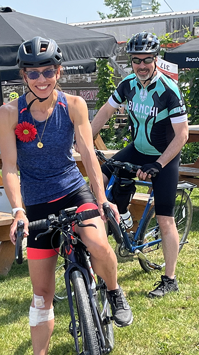 Happy woman and man cyclists wearing Myeloma Canada flower at Myeloma Canada Ride, Vankleek Hill, ON